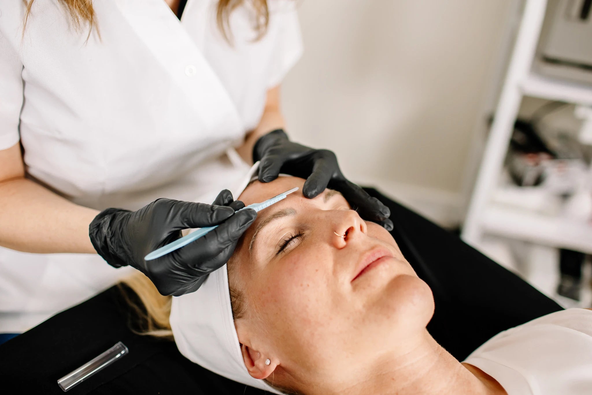 Woman receiving dermaplaning treatment